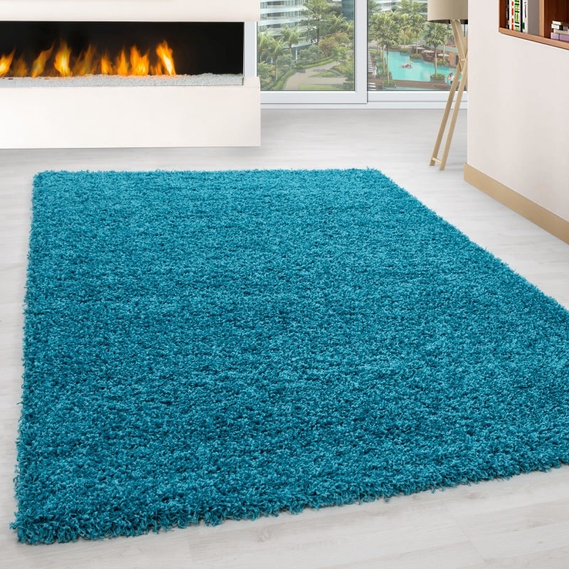 Luna Ensfarvet Fluffy Gulvtæppe i Turkis fra Rugs by Uniquebeds Home & Living | Flere Størrelser i Firkantet & Rund